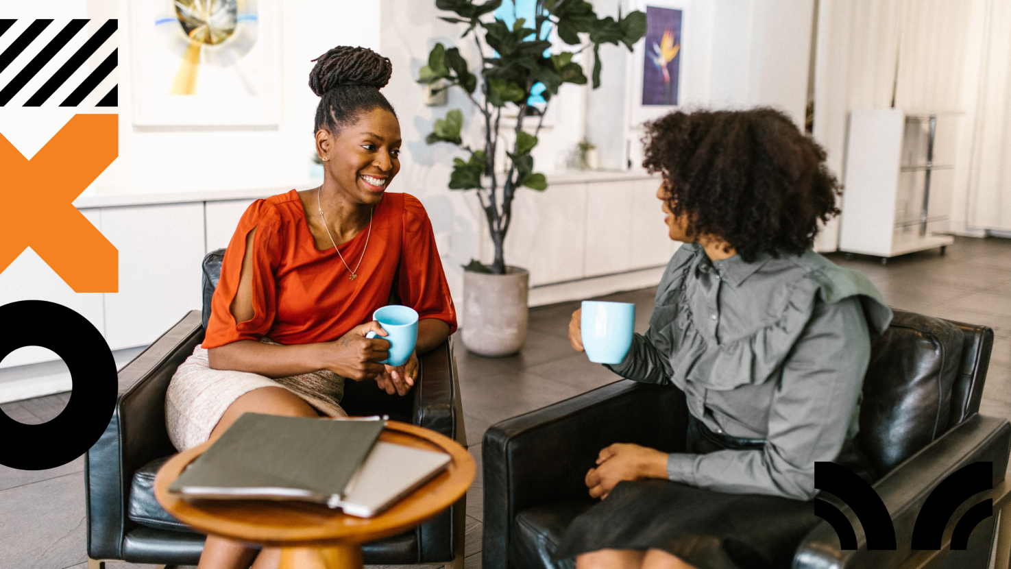 2 women sitting and talking with coffee