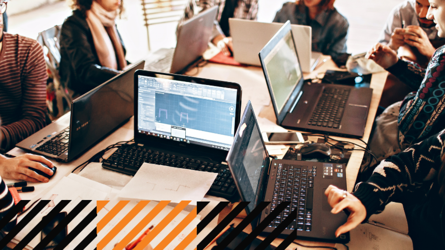 a team all working at their laptops in an office