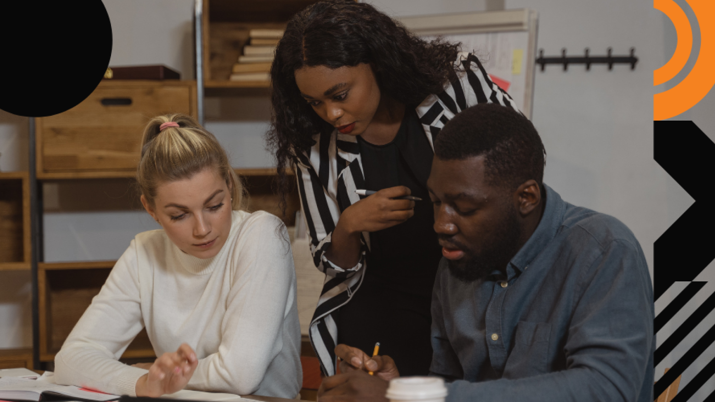 3 coworkers analyzing at a desk together