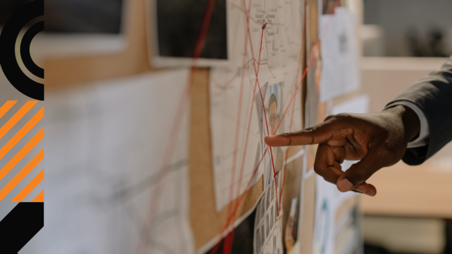 person pointing to data on a detectives bulletin board