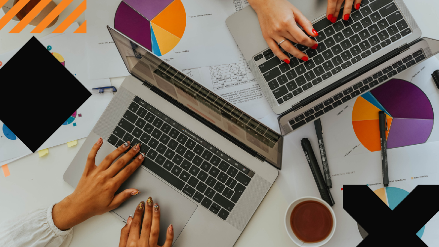 2 people working at their laptops - only hands are viewable