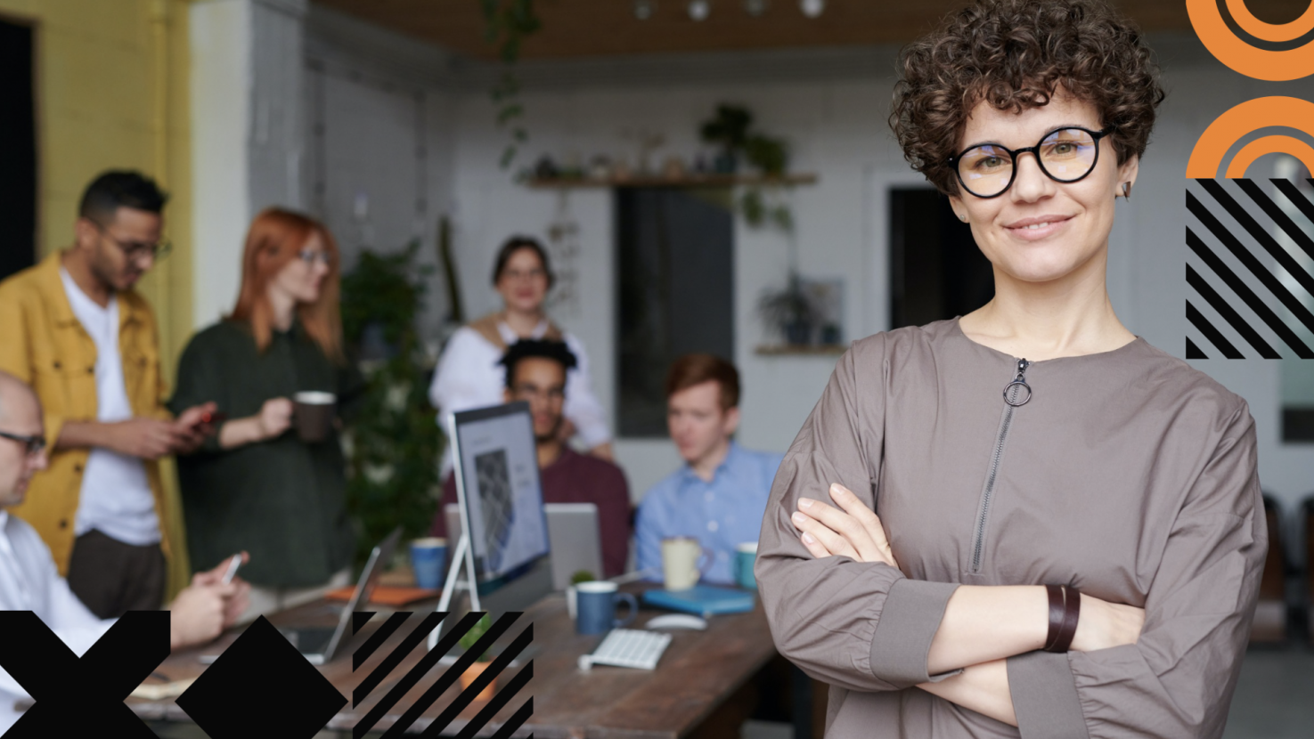 a team standing and working behind a leader