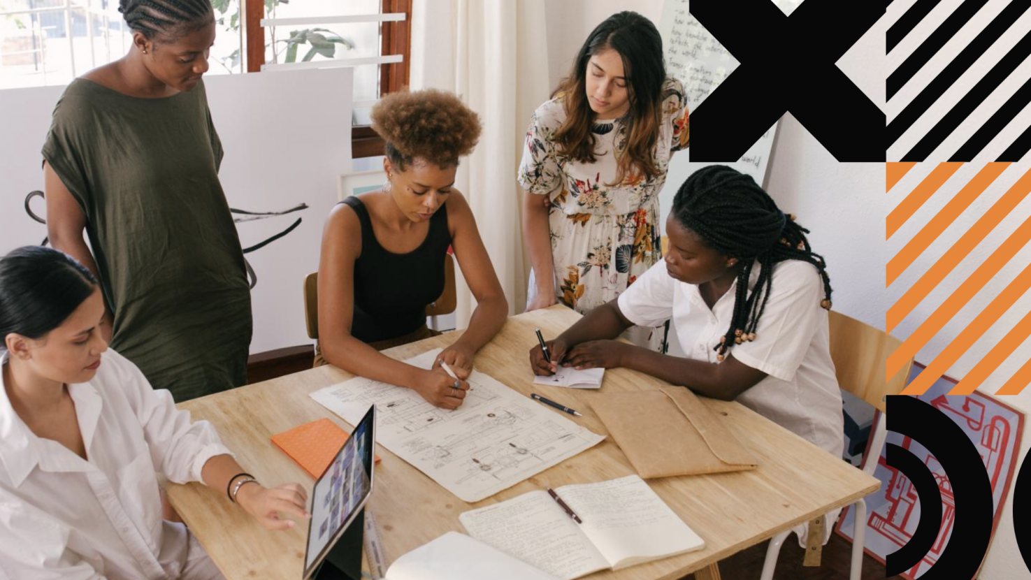 teammates working at a big desk together