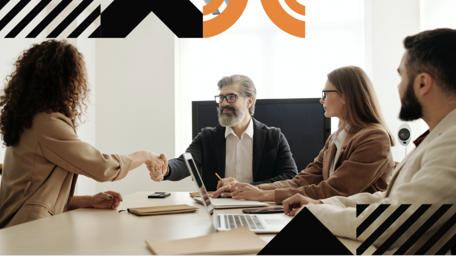 coworkers shaking hands at a large table