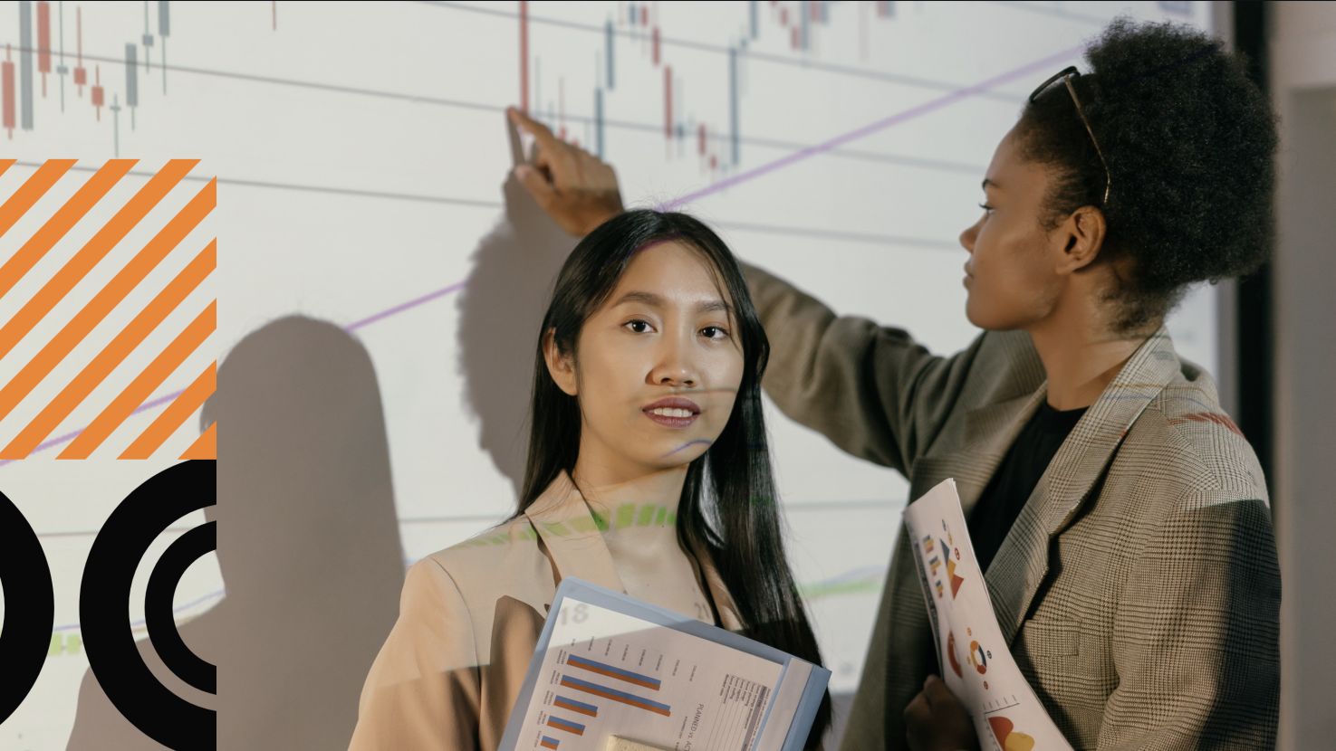 2 people presenting in front of a screen with data