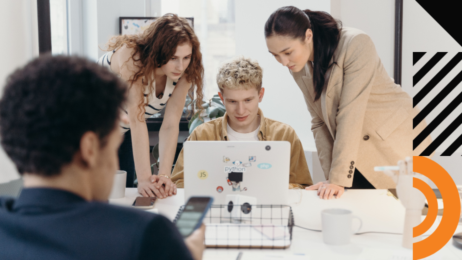 Coworkers working together and looking at a laptop