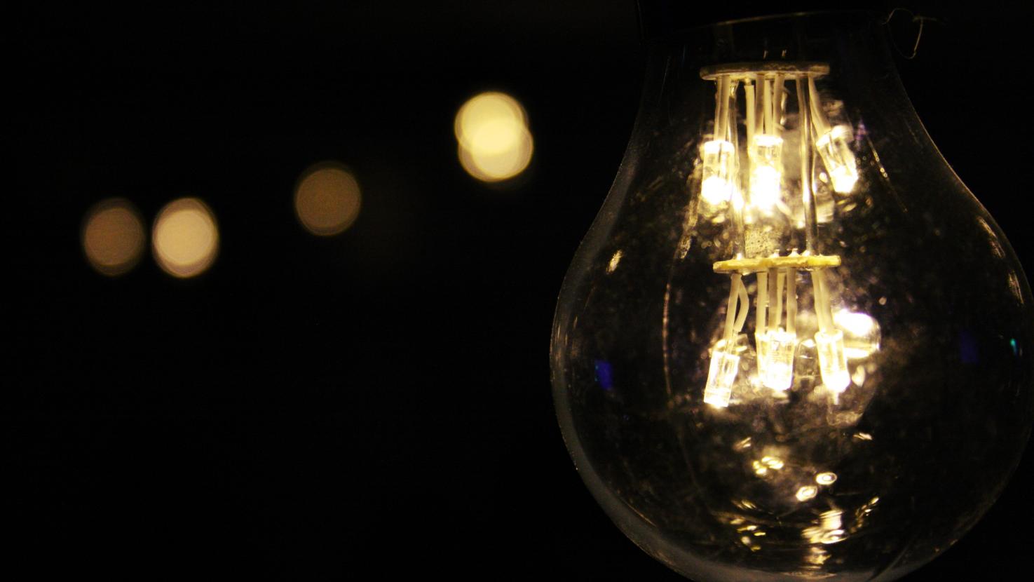 shining lightbulb with dark blurred background
