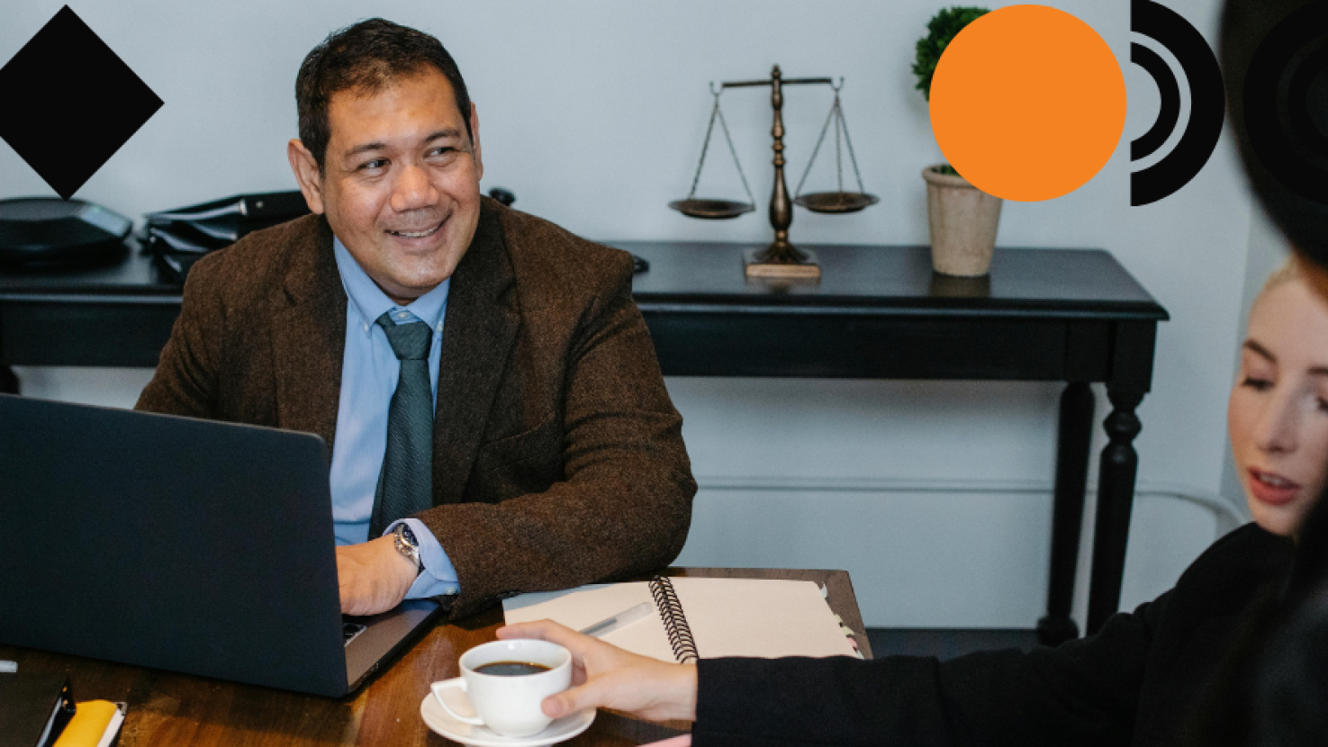 man smiling at his desk