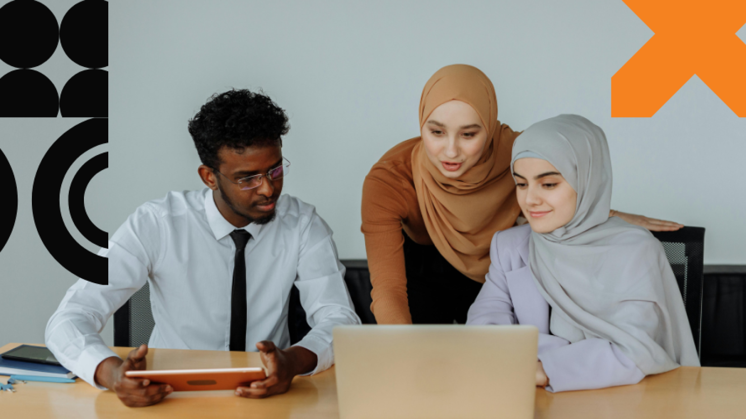 Three coworkers working at their laptop