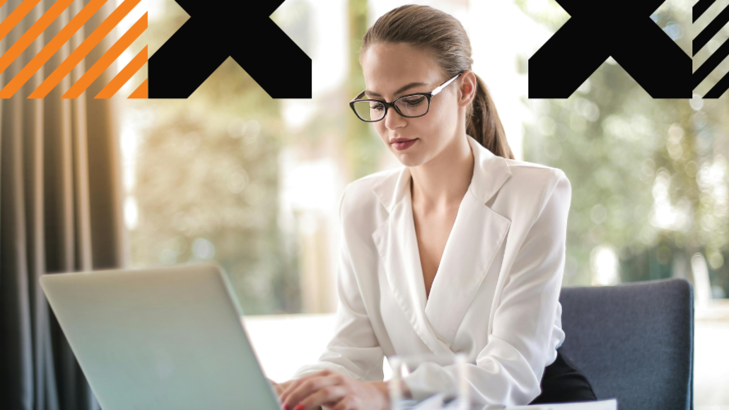 Woman working at her desk with a laptop